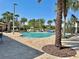 Large outdoor community pool with deck, lounge chairs and palm trees for a resort-like feel at 1440 Pro Shop Ct, Davenport, FL 33896