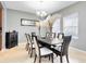 Elegant dining room with a modern chandelier, a dark wood table with seating for eight, and bright, airy windows at 1440 Pro Shop Ct, Davenport, FL 33896