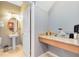Stylish half bathroom with a pedestal sink, granite countertop, and a well-lit vanity area, perfect for guests at 1440 Pro Shop Ct, Davenport, FL 33896
