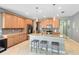 Spacious kitchen featuring an island with pendant lighting, ample wooden cabinetry, stainless steel appliances, and tile flooring at 1440 Pro Shop Ct, Davenport, FL 33896