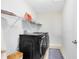 Well-equipped laundry room featuring modern black washer and dryer units at 1440 Pro Shop Ct, Davenport, FL 33896