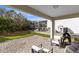 Cozy covered patio with outdoor seating and grilling area at 1440 Pro Shop Ct, Davenport, FL 33896