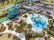 Aerial view of a community water park with water slides, pools, and a playground at 1440 Pro Shop Ct, Davenport, FL 33896
