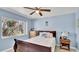 Comfortable bedroom features seaside decor and quilt with a view of trees through the window at 1461 Helena Ct, Deltona, FL 32725