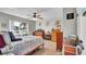 Bedroom featuring multiple dressers, a ceiling fan, and views of a lake through the window at 1461 Helena Ct, Deltona, FL 32725