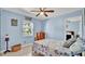 Light-blue bedroom with seaside decor, including a seashell-patterned quilt and nautical artwork at 1461 Helena Ct, Deltona, FL 32725