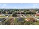 An aerial view of the property showcasing the neighborhood and mature trees at 14889 Sw 46Th Ct, Ocala, FL 34473