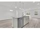 Kitchen island featuring stainless steel dishwasher, cabinets, and faucet with pendant lights and open layout at 14889 Sw 46Th Ct, Ocala, FL 34473