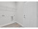 Bright laundry room featuring a wire rack shelf, utility connections, and an entry door at 14889 Sw 46Th Ct, Ocala, FL 34473