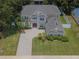 Stunning aerial view of a two-story home featuring a paved driveway and well-manicured lawn in a suburban neighborhood at 15313 Hayworth Dr, Winter Garden, FL 34787