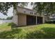 View of the home's exterior and large backyard with a screened-in patio at 15313 Hayworth Dr, Winter Garden, FL 34787