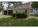 This home has a spacious backyard with green grass and well-manicured shrubbery, offering a peaceful outdoor space at 15313 Hayworth Dr, Winter Garden, FL 34787