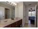 Bathroom featuring a double sink vanity, tile floors, and an open doorway at 15313 Hayworth Dr, Winter Garden, FL 34787