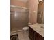 Cozy bathroom featuring a glass shower and a vanity with a dark wooden cabinet at 15313 Hayworth Dr, Winter Garden, FL 34787