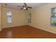 Bright bedroom with hardwood floors and two windows at 15313 Hayworth Dr, Winter Garden, FL 34787