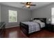 Comfortable bedroom with wood floors, large window, and ceiling fan at 15313 Hayworth Dr, Winter Garden, FL 34787