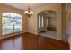 Formal dining room boasts hardwood floors, an elegant chandelier, and a view of the front yard at 15313 Hayworth Dr, Winter Garden, FL 34787