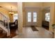 Grand foyer with tile flooring, staircase, and an entryway leading to the living spaces at 15313 Hayworth Dr, Winter Garden, FL 34787