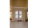 Bright foyer features double front doors with decorative glass and neutral tile flooring at 15313 Hayworth Dr, Winter Garden, FL 34787