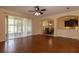 Spacious living area showcases hardwood floors and sliding glass doors to the lanai at 15313 Hayworth Dr, Winter Garden, FL 34787