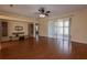 Open living space features hardwood floors, a ceiling fan, and sliding glass doors to the lanai at 15313 Hayworth Dr, Winter Garden, FL 34787