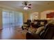 Spacious living room featuring hardwood floors, comfortable seating, and an open layout at 15313 Hayworth Dr, Winter Garden, FL 34787