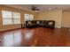 Comfortable living room featuring a leather sectional, ceiling fan, and wood floors at 15313 Hayworth Dr, Winter Garden, FL 34787