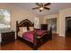 Comfortable main bedroom with hardwood floors, ceiling fan, dresser, and large windows for plenty of light at 15313 Hayworth Dr, Winter Garden, FL 34787