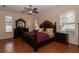 Elegant main bedroom featuring hardwood floors, a ceiling fan, and ample natural light from the windows at 15313 Hayworth Dr, Winter Garden, FL 34787