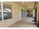Spacious covered patio with ceiling fans and sliding glass doors at 15313 Hayworth Dr, Winter Garden, FL 34787