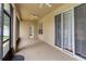 Covered patio with ceiling fan and sliding glass doors at 15313 Hayworth Dr, Winter Garden, FL 34787