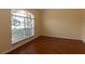 Neutral room with wood floors and a large window is ready for your personal touch at 15313 Hayworth Dr, Winter Garden, FL 34787