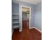 Walk-in closet with custom shelving and hardwood floors at 15313 Hayworth Dr, Winter Garden, FL 34787
