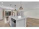 Kitchen with white cabinets, stainless steel appliances, a center island, and wood-look flooring at 15318 Beamleigh Rd, Winter Garden, FL 34787