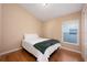 This cozy bedroom offers hardwood floors and a window providing ample natural light at 15341 Urbino Ln, Orlando, FL 32828