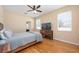 Cozy bedroom with ceiling fan, wood floors and plenty of natural light at 15341 Urbino Ln, Orlando, FL 32828