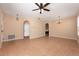 This empty living room offers tile flooring, arched entryways, and modern lighting at 15341 Urbino Ln, Orlando, FL 32828