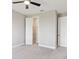 Comfortable bedroom with plush carpet, a ceiling fan, and white doors at 1595 Juniper Hammock St, Winter Garden, FL 34787