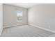 Well-lit bedroom with soft carpet, neutral paint, and window at 1595 Juniper Hammock St, Winter Garden, FL 34787