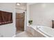 Well-lit bathroom featuring a soaking tub and tiled walk-in shower with neutral color palette at 18468 Sabal St, Orlando, FL 32833