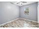 Bedroom with wood-look floors, a ceiling fan, and neutral walls at 18468 Sabal St, Orlando, FL 32833