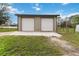 A detached, two-car garage is situated on a large lot and includes a concrete driveway at 18468 Sabal St, Orlando, FL 32833