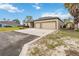 Exterior view of a one story home, showcasing its two-car garage and manicured lawn at 18468 Sabal St, Orlando, FL 32833