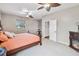 Main bedroom featuring carpet floors, ceiling fans, natural light, and cozy furniture at 18468 Sabal St, Orlando, FL 32833