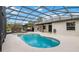 Screened-in pool area with a sparkling pool, spa, and exterior backyard at 18468 Sabal St, Orlando, FL 32833