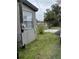 Image of the exterior of a home with grassy lawn, adjacent driveway, and palm tree in view at 18541 15Th Ave, Orlando, FL 32833