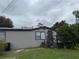 Exterior view of gray home with tidy lawn and porch leading to front door at 18541 15Th Ave, Orlando, FL 32833