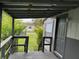 View from covered porch with wood railings to the house's front door at 18541 15Th Ave, Orlando, FL 32833