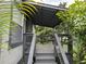 Image of covered front porch featuring wood stairs and view of landscaping at 18541 15Th Ave, Orlando, FL 32833