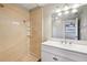 Bright bathroom featuring a shower with neutral tiles and a modern sink vanity at 2021 Canal Rd, Deltona, FL 32738